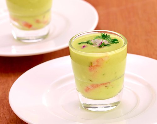 Shot of guacamole with extra small cocktail shrimp