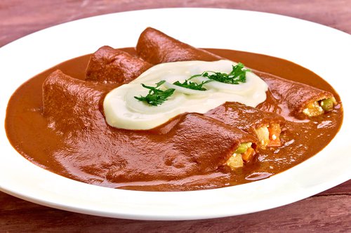 Mole enchiladas filled with anejo cheese